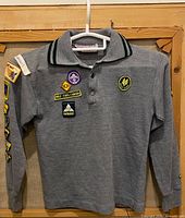 Front view of grey knit Cub jersey with patches visible