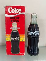 Radio beside original Coke branded box, full view