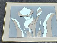 Front view of smoked glass floral mirror within gold frame