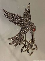 Full brooch front view showing hummingbird and flower design