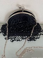 Front view of black beaded Bijoux Terner evening purse showing chain strap and kiss-lock frame