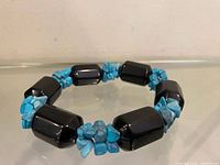 Full view of bracelet showing alternating onyx cylinders and turquoise chips