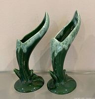 Front view of both sculptural green drip vases