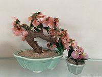 Large and small Chinese stone bonsai sculptures side by side
