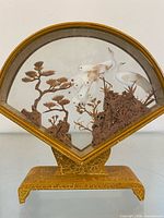 Full view of fan-shaped cork carving diorama on stand