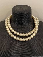 Necklace shown doubled on display bust to illustrate appearance