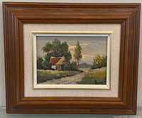 Frontal view of framed oil painting showing landscape and frame
