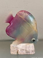 Front view of rainbow onyx angelfish figurine on stone base