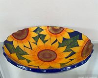 Top view showing sunflower design and blue rim