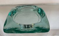 Top view of square green glass ashtray