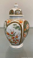 Front view of ginger jar showing bird and floral panels