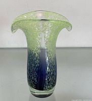 Full view showing speckled green top, purple lower section, double flared rim