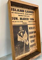 Entire framed poster angled view showcasing frame depth and full text