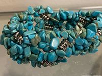 close view of turquoise chip and silver-tone spacer bracelet