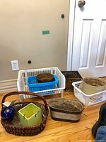 Group of planters, baskets and bins on floor
