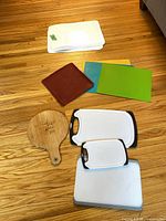 Group shot of all cutting boards, mats and trivet on floor