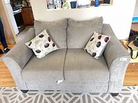 front view of loveseat with two throw pillows