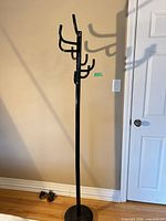 full view of black metal coat rack showing hooks and base