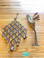 Wind chime and bird stake laid on floor showing overall design and condition