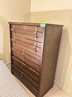 Full view of dark brown five-drawer dresser