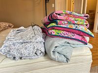 Stack showing quilt, heated blanket, folded sheets