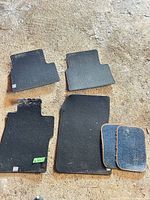 Entire 6-piece set laid out: four black mats, two blue inserts