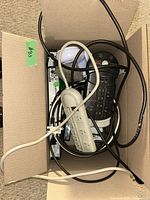 Box containing power strips, cables and LED bulb