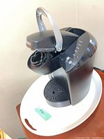 Front left view with brew head open showing K-Cup chamber and drip tray