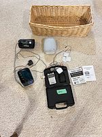 Group shot showing blood pressure monitor, TENS kit, Google Nest, and wicker basket