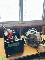 Overall view of circular saw and bin of hand tools
