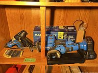 Reciprocating saw, charger, case, auxiliary handle and blades on shelf