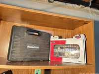 Closed Mastercraft carry case next to boxed Jobmate accessory set