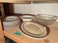 Stack of Myott dinner plates, single plate displayed, and glass punch bowl