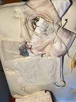 All items laid out: folded shower curtain, heating pad, bag of metal hooks