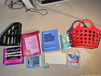 All items laid out: basket, file holder, construction paper, calculator, book, coupon file, envelopes, tack cloth