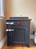 Front view of nightstand showing drawer, door and child safety latches
