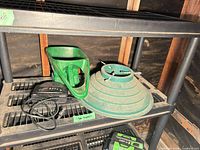 Sony clock radio, tree collar rings, handheld spreader and Ryobi items on shelving