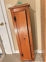 Full view of tall narrow cabinet closed