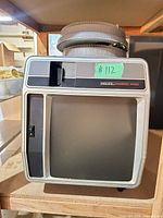 Front view showing Telex Caramate 4000 projector with slide tray on top