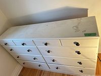 Front view of white dresser with 10 drawers and knob pulls