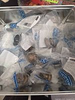 Container holding multiple sealed Amerock cabinet knob bags