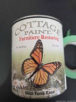 Front label of Cottage Paint can showing brand, product type, butterfly graphic