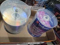 Two shrink-wrapped spindles of blank DVD+R discs: Verbatim AZO and generic