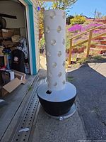 Full view of white planting tower seated in black reservoir