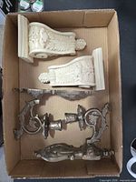 Pair of resin corbels and pair of metal sconces inside box
