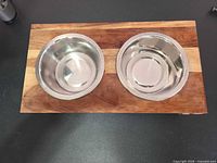 Top view showing two stainless bowls fitted in wooden stand