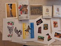 Group shot of assorted cards, prints and memo pad
