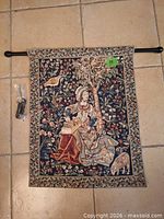 Full view of tapestry with hanging rod and packaged brackets