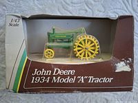 Front of boxed 1:43 scale John Deere 1934 Model A die-cast tractor