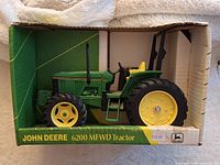 Front view of boxed John Deere 6200 MFWD die-cast tractor